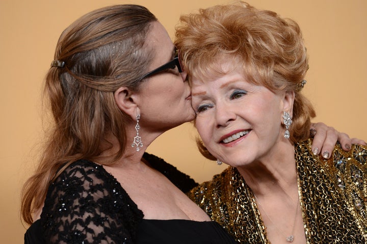 Debbie Reynolds and Carrie Fisher pose in the press room at the 21st Annual Screen Actors Guild Awards on Jan. 25, 2015.