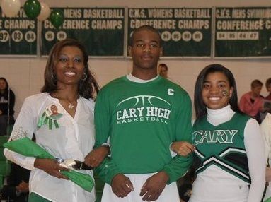 Then student-athlete DomiNick Downing poses with family members at 2011 Cary High School Senior Night. 