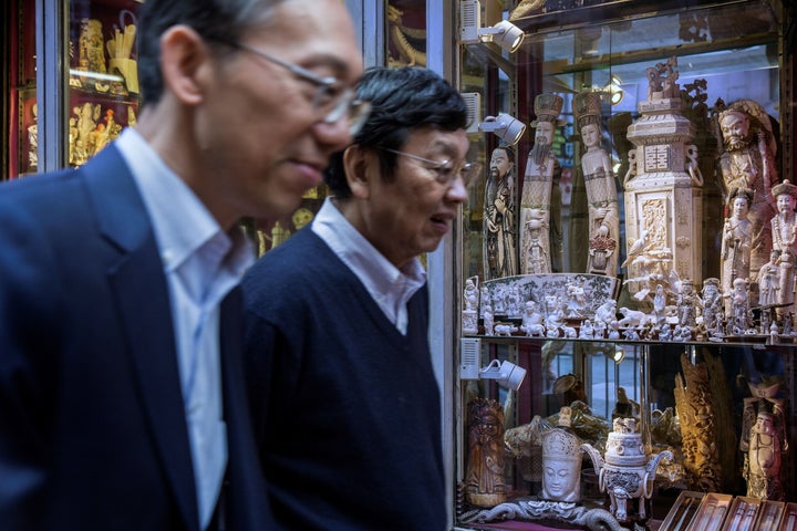 Members of the public walk past a shop selling ivory products in Hong Kong on Dec. 21. Hong Kong is a major transit hub for the world ivory trade.