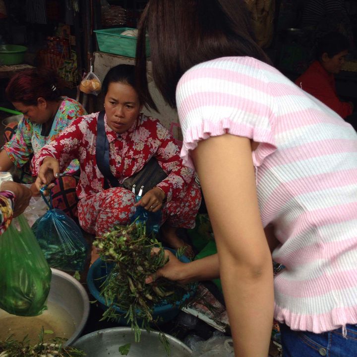 A garment worker buys vegetables at the local market near her home in Phnom Penh.
