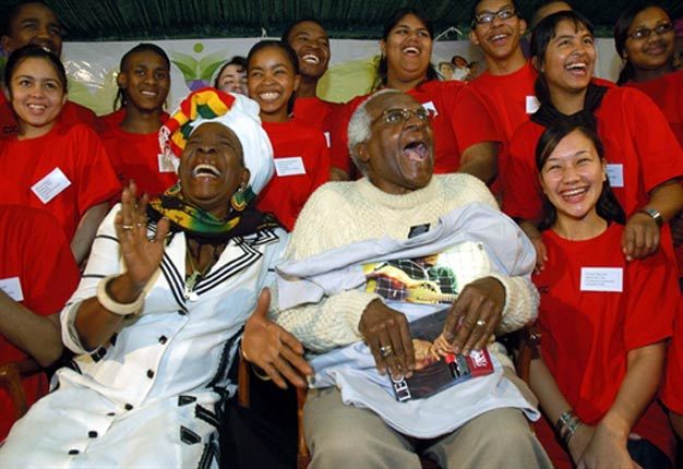 Desmond Tutu shares a laugh with Rita Marley, wife of Bob Marley, during a meeting with 20 young people.