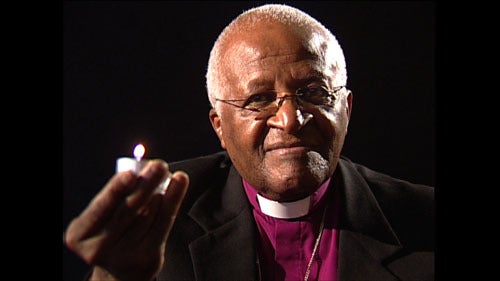 <p><em>Archbishop Tutu lights a candle for the survivors of genocide in Rwanda.</em></p>