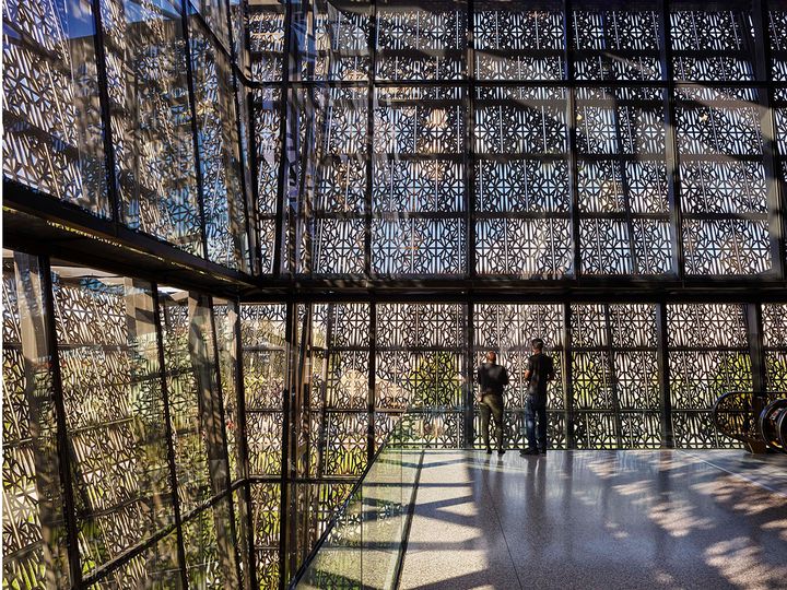 Interior of the museum, with views of the exterior through the latticework. 
