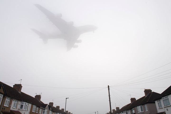 A Etihad Airways Airbus A380 comes in through the fog to land at Heathrow Airport yesterday