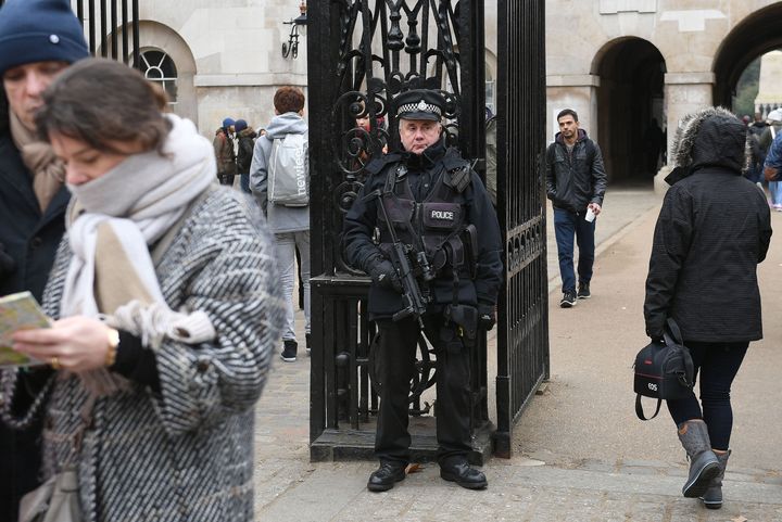 <strong>An armed police officer stands outside Horse Guards Parade in central London, ahead of the New Year celebrations</strong>