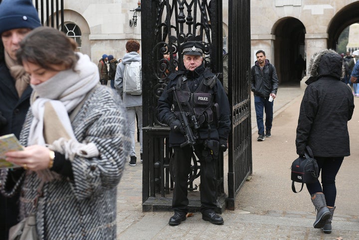 An armed police officer stands outside Horse Guards Parade in central London, ahead of the New Year celebrations