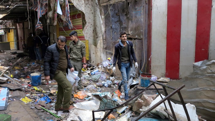 Iraqi security forces gather at the site of a bomb attack at a market in central Baghdad, Iraq December 31, 2016.