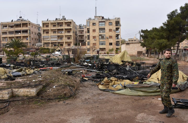 A Russian soldier inspects the damage at a field hospital that was reportedly destroyed by rebel shelling on December 5, 2016 in west Aleppo.