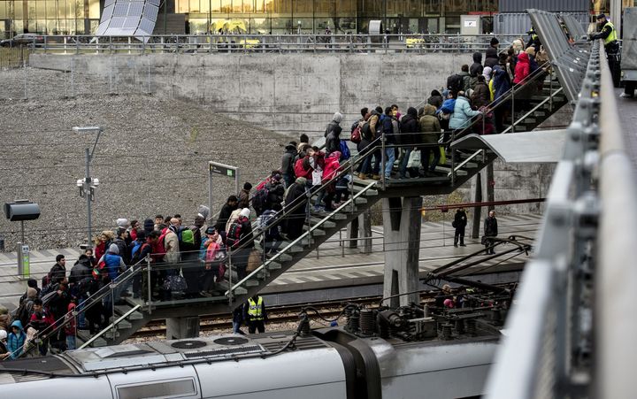 Denmark passed a new law on Tuesday that deters refugees from seeking asylum. Above, police organize a line of refugees on a stairway leading up to trains arriving from Denmark on Nov. 19, 2015.