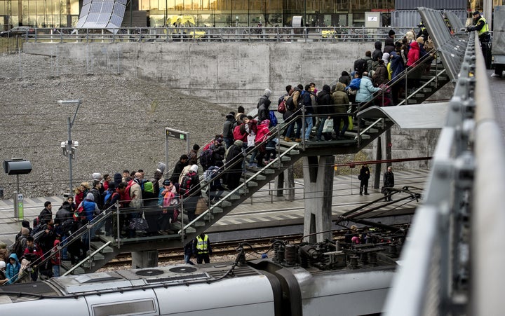 Denmark passed a new law on Tuesday that deters refugees from seeking asylum. Above, police organize a line of refugees on a stairway leading up to trains arriving from Denmark on Nov. 19, 2015.