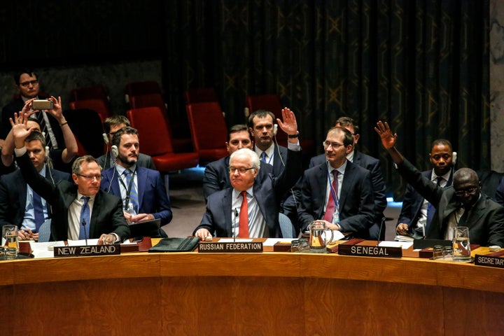 Russian Ambassador to the UN Vitaly Churkin (C) votes at the Security Council on a Russian-Turkish peace plan for Syria, on D