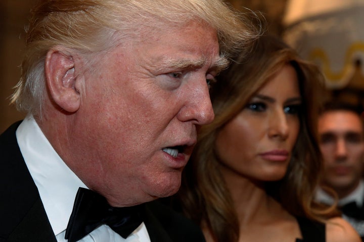 President-elect Donald Trump talks to reporters as he and his wife, Melania, arrive for a New Year's Eve celebration with members and guests at the Mar-a-Lago Club in Palm Beach, Florida, on Dec. 31.