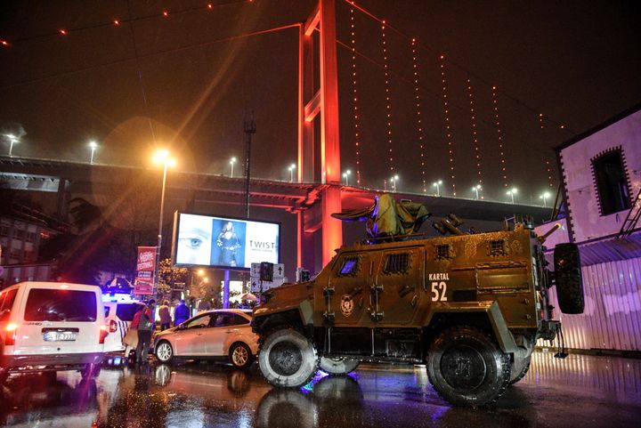 A police armoured vehicle blocks the road leading to the scene.