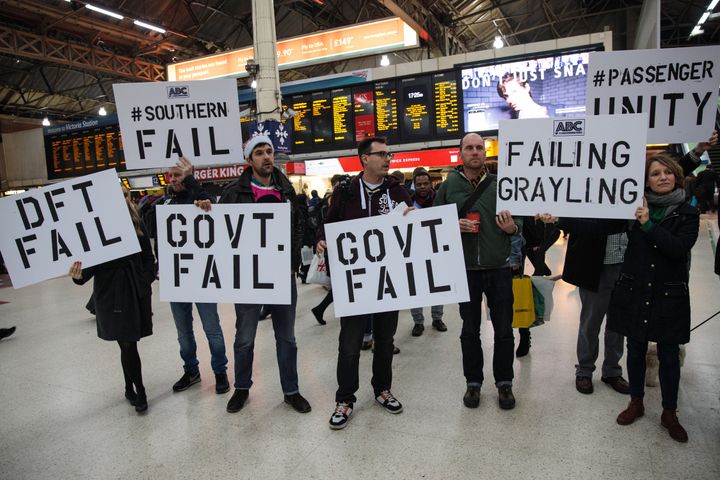 Demonstrators holding placards stage a protest at Victoria Station in December.
