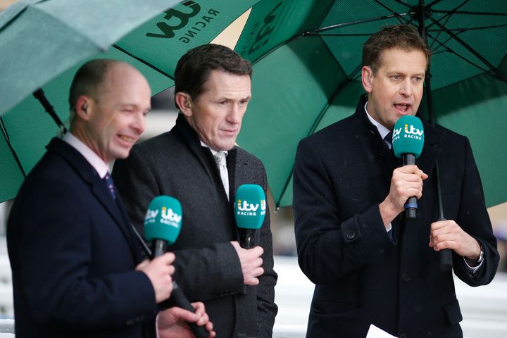 The ITV Racing team of presenter Ed Chamberlain (R) with AP McCoy (C) and Luke Harvey at Cheltenham Racecourse on January 1.