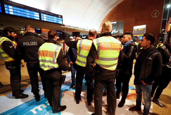 Police officers of Germany's federal police Bundespolizei check young men at the main railways station following New Year celebrations in Cologne, Germany, January 1, 2017.