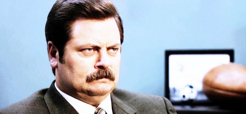 <em>Parks and Recreation</em>’s Ron Swanson(Nick Offerman) scowls uncomfortably.