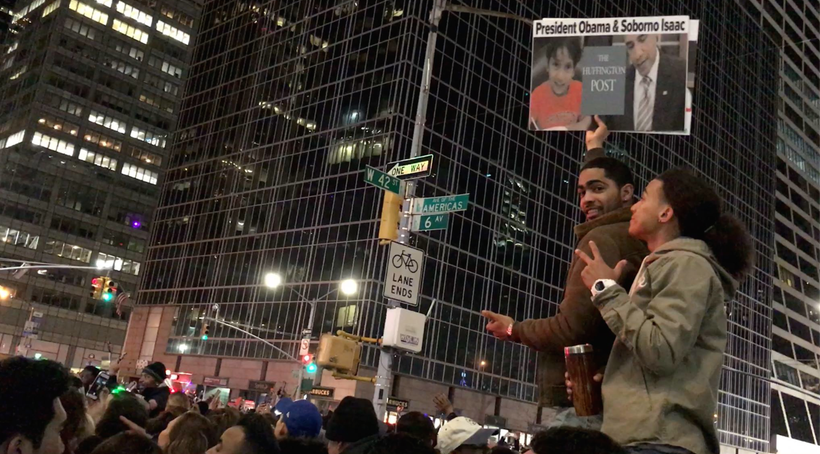 Fans of Isaac promote this article at Times Square where millions of people have gathered to celebrate New Year on 31st night