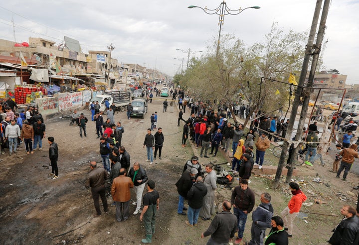 People gather at the site of car bomb attack in a busy square at Baghdad's sprawling Sadr City district, in Iraq January 2, 2017.