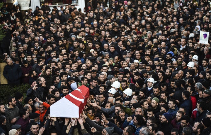 People carry the coffin of Yunus Gormek, 23, one of the victims of the Reina night club attack, during his funeral ceremony on Jan. 2, 2017, in Istanbul.