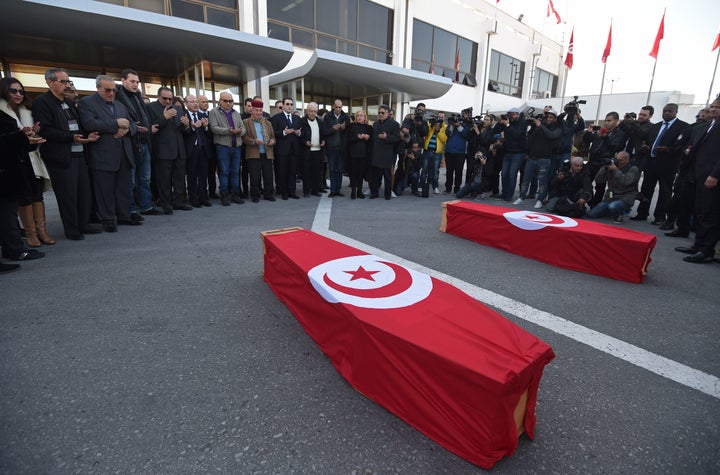 Mourners pray around the coffins of a Franco-Tunisian couple who were victims of the attack at the Reina nightclub.