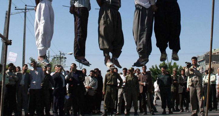 Iranians watch the hanging of a convicted man in 2011. Iran has executed at least 73 young offenders in the past decade, a new report has found.