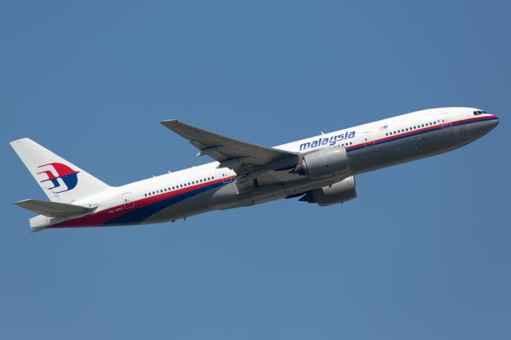 A Malaysia Airlines Boeing 777, the sister airplane of the missing aircraft, takes off in Frankfurt, Germany. A piece of