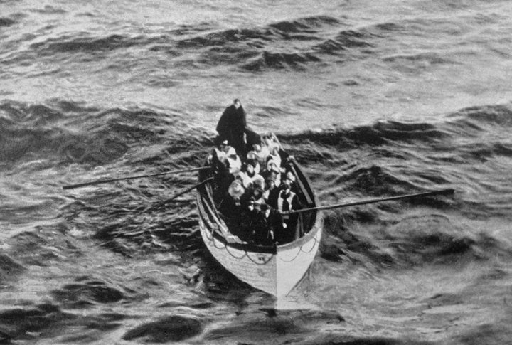 An emergency cutter lifeboat carrying a few survivors from the Titanic is seen floating near the rescue ship Carpathia on the morning of April 15, hours after the disaster.