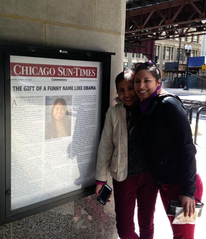 Me and my mom posing with the blown up version of my 2013 op-ed: ‘The Gift of Funny Name Like Obama,’ on display at DePaul’s CDM building in Chicago’s loop.