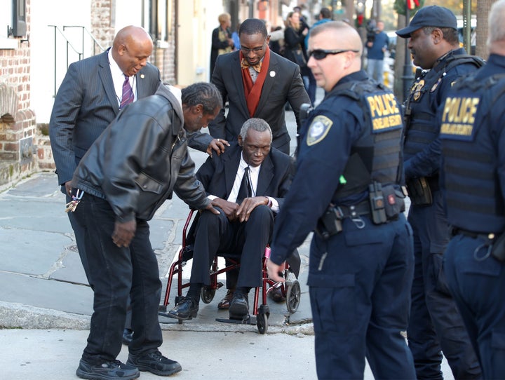 John Pinckney (in wheelchair), the father of Dylann Roof shooting victim Rev. Clementa Pinckney, leaves the Charleston Federal Courthouse after Roof was found guilty on 33 murder and hate crime counts in Charleston in December.