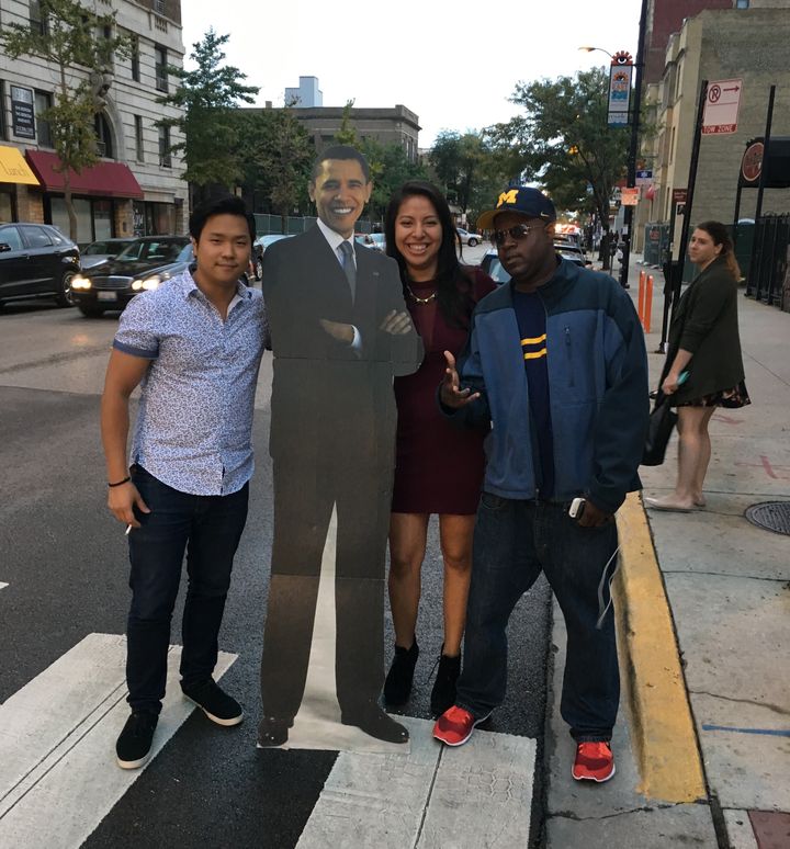 Three random strangers brought together by a cut-out of Barack Obama.