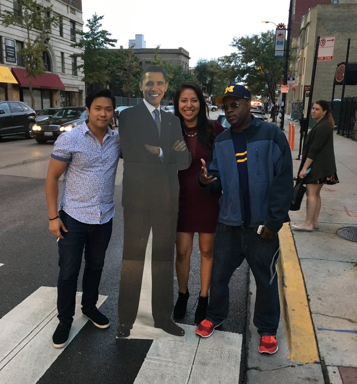 <p>Three random strangers brought together by a cut-out of Barack Obama.</p>