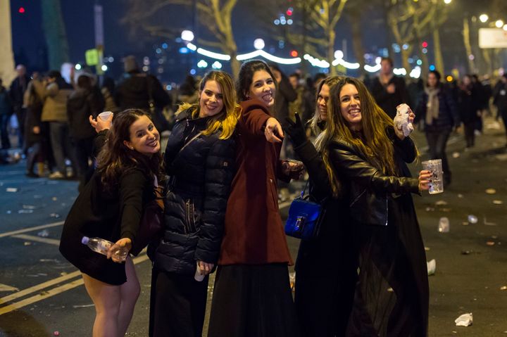 A group of friends pose for a picture on the Albert Embankment in central London while attending the New Year celebrations.