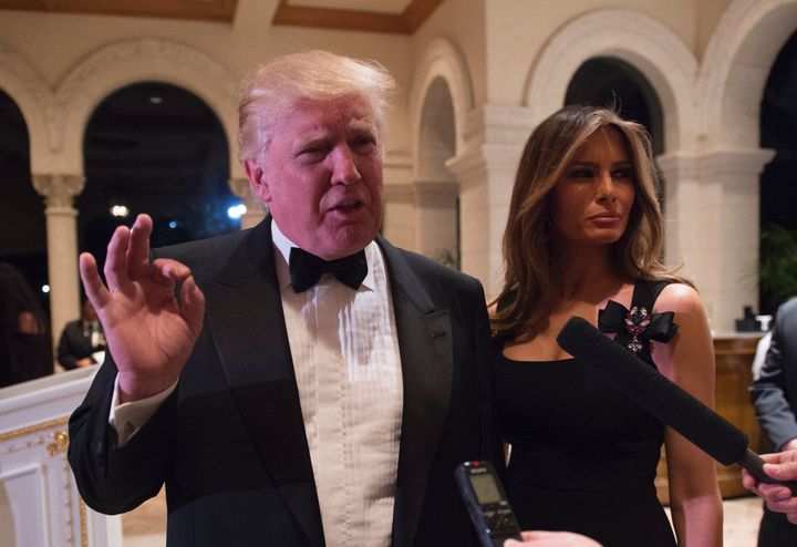 President-elect Donald Trump answers questions from reporters as he and his wife, Melania, attend a New Year's Eve party at Mar-a-Lago in Palm Beach, Florida.