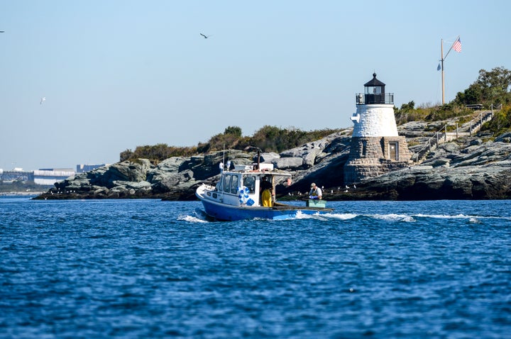 A local fisherman near a lighthouse in Newport, Rhode Island. The Ocean State recently banned the sale and ownership of shark