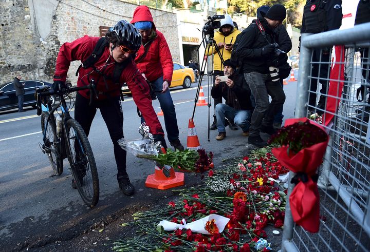 A mourner lays flowers front of the Reina nightclub on January 2, 2017 in Istanbul, one day after a gunman killed 39 people