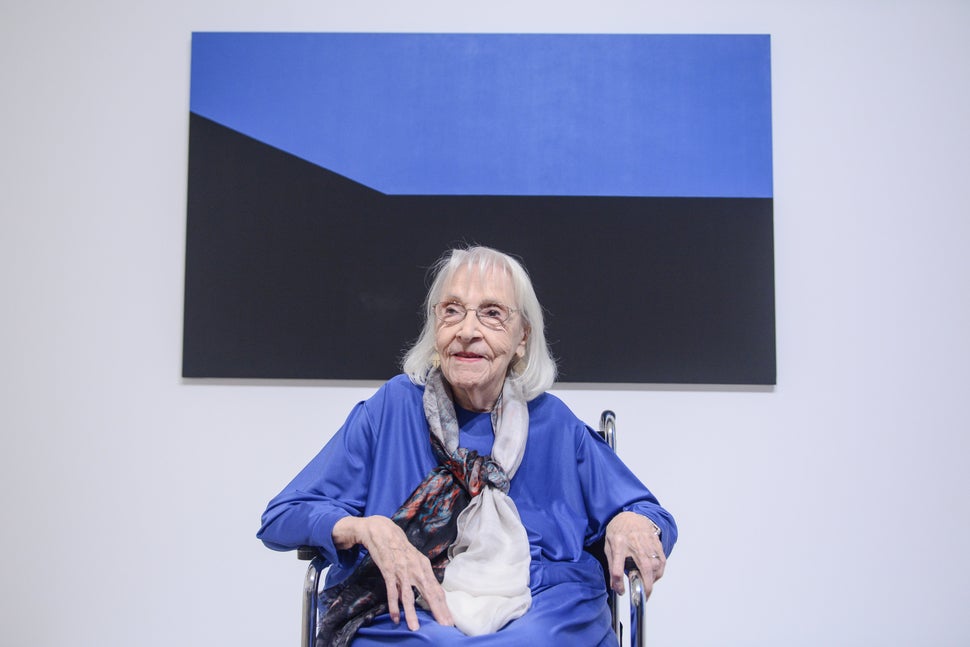 Portrait of Carmen Herrera in front of Blue Monday, 1975, acrylic on canvas, as installed in "Carmen Herrera: Lines of Sight"