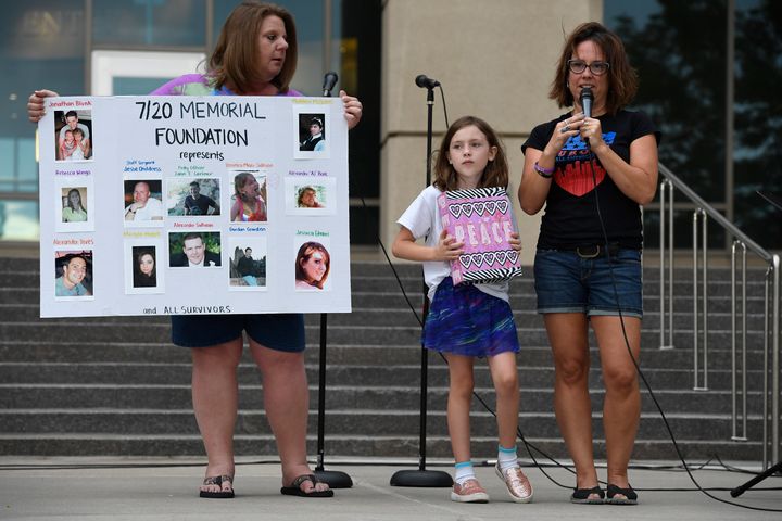 Heather Dearman, far right, and her daughter Aubry, 8, cousins of Aurora Theater shooting victim Veronica Moser-Sullivan, talk to the crowd gathered for a remembrance ceremony for the 4th anniversary of the Aurora Theater shooting on July 20, 2016 in Aurora, Colorado.