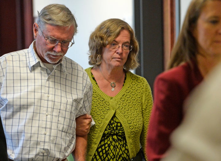 Robert and Arlene Holmes, parents of Aurora theater shooting suspect James Holmes, walk from the courtroom at the Arapahoe County Justice Center for a hearing in the 2012 Colorado movie theatre shooting case, July 22, 2014.