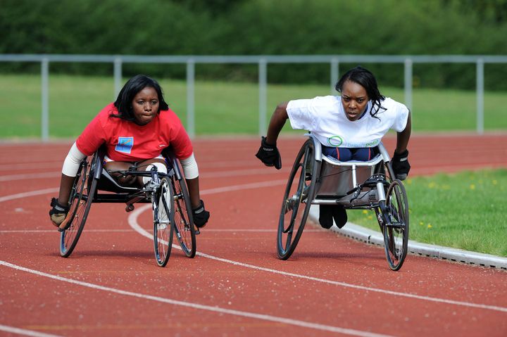 Wafula Strike coaching Dedeline Mibamba Kimbatahas (left) a Paralympian from the Democratic Republic of Congo in 2012