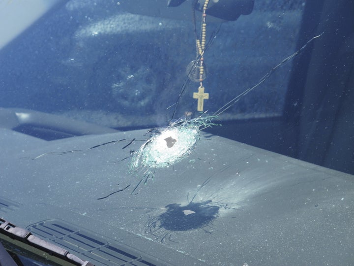 A bullet hole is shown in a windshield of a car that was traveling on Interstate 10 in Phoenix, Arizona in the handout photo