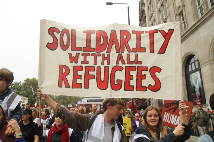 LONDON, UK - September 17: Demonstrators carry a banner during thr Refegees Welcome march through London to show solidarity with Refugees on 17 September 2016. The march from Hyde Park to Parliament Square follows reports of the many people who have lost their lives including a young boy Aylan Kurdi trying to flee from their war torn countries to safety in Europe. Last year the government agreed to resettle 20,000 Syrian refugees. (Photo by David Mbiyu/Corbis via Getty Images)