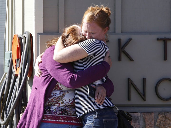 Umpqua Community College alumnus Donice Smith (L) is embraced after she said one of her former teachers was shot dead, near the site of a mass shooting at Umpqua Community College in Roseburg,Oregon October 1, 2015.