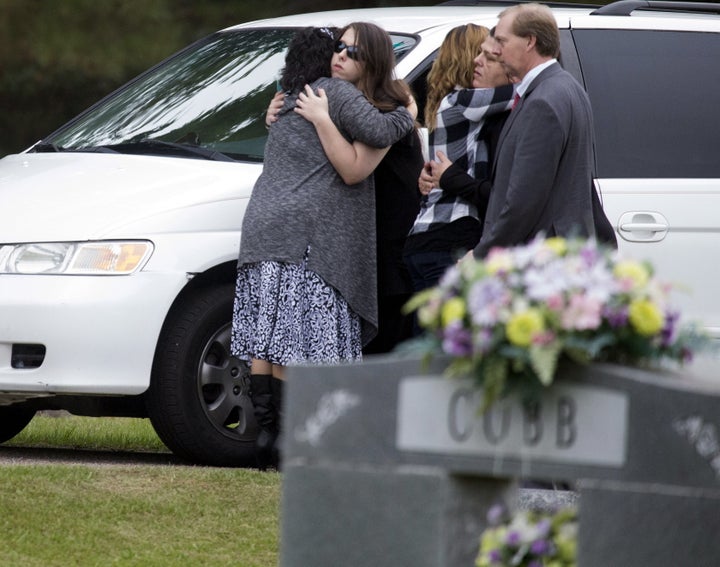 Mourners, believed to be family members, embrace as they gather for the burial of six-year old Jeremy Mardis at a cemetery in Beaumont, Mississippi, November 9, 2015.