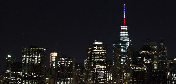One World Trade Center's spire is shown lit in French flags colors of white, blue and red in solidarity with France after tonight's terror attacks in Paris, November 13, 2015 in New York City.