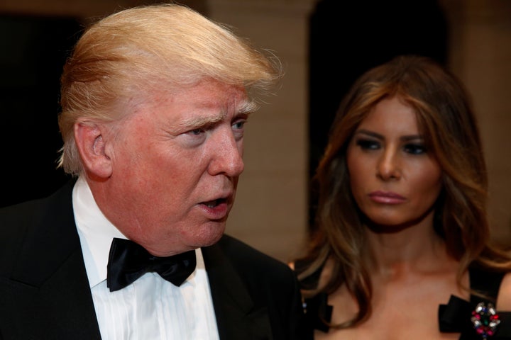U.S. President-elect Donald Trump talks to reporters as he and his wife Melania Trump arrive for a New Year's Eve celebration