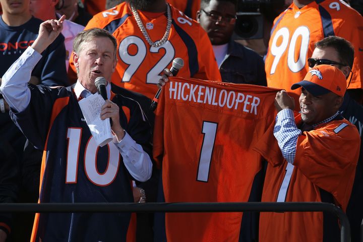 (L-R) Colorado Governor John Hickenlooper and Denver Mayor Michael Hancock display the jersey that North Carolina Gov. Pat McCrory will wear as part of their wager as the Super Bowl 50 Champion Denver Broncos are honored at a rally on the steps of the Denver City and County Building on February 9, 2016 in Denver, Colorado.