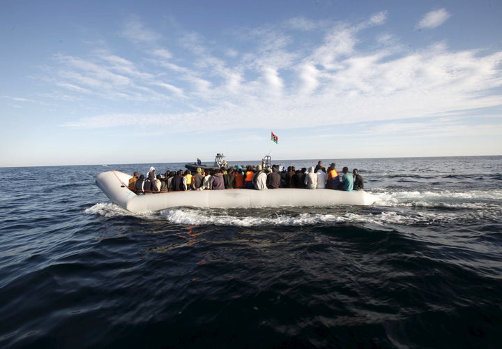 Migrants, who tried to flee to Europe, travel in a dinghy after they were stopped by Libyan coast guards and made to head to Tripoli September 29, 2015.