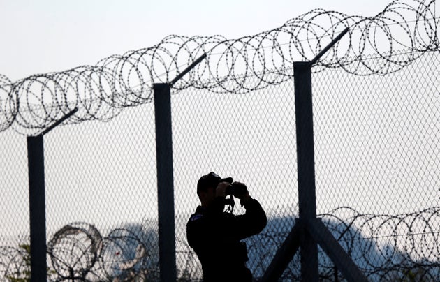 A Polish policeman patrols at the Hungary and Serbia border fence near the village of Asotthalom, Hungary,...