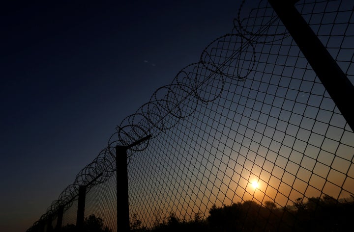 The sun rises along the Hungary and Serbia border fence near the village of Asotthalom, Hungary, October 2, 2016.